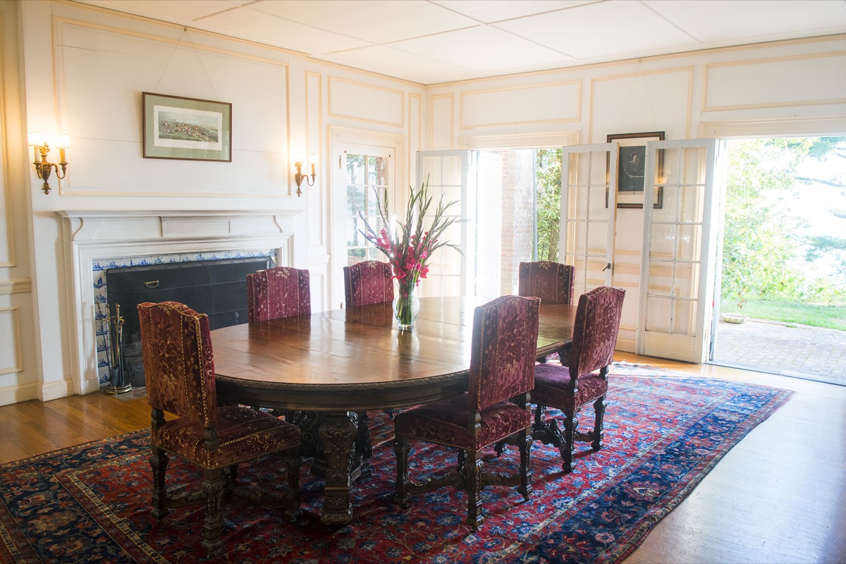 The dining table extended for a large seated dinner, French doors open to the terrace