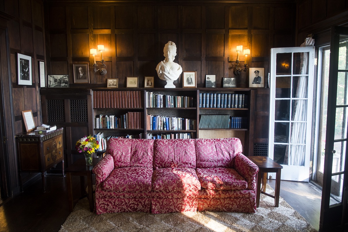 The library’s shelves of books with armchairs facing the bay windows