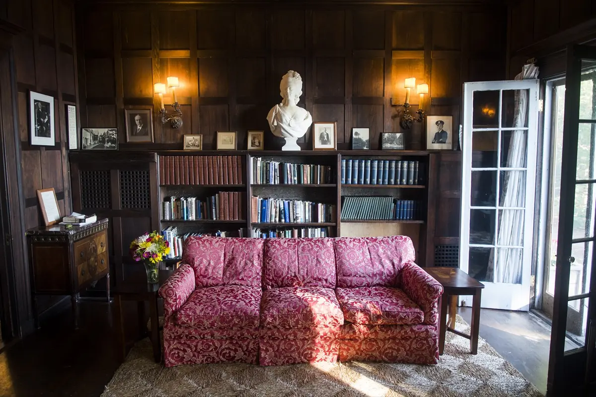 The library’s shelves of books with armchairs facing the bay windows