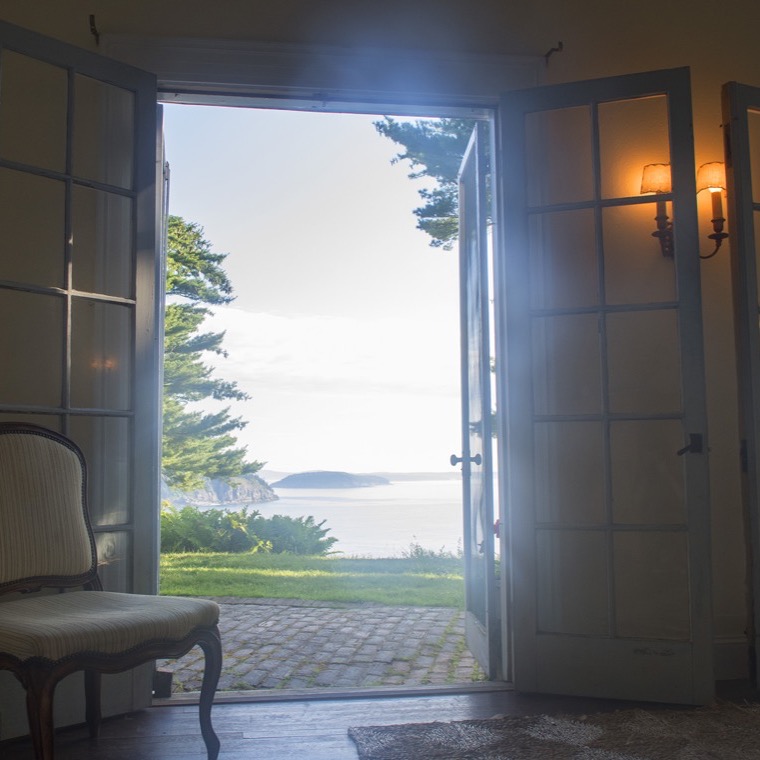 The living room with French doors opening toward the terrace