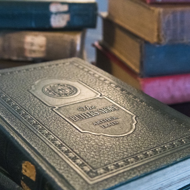 A portrait and books belonging to Arthur Train, who commissioned the house