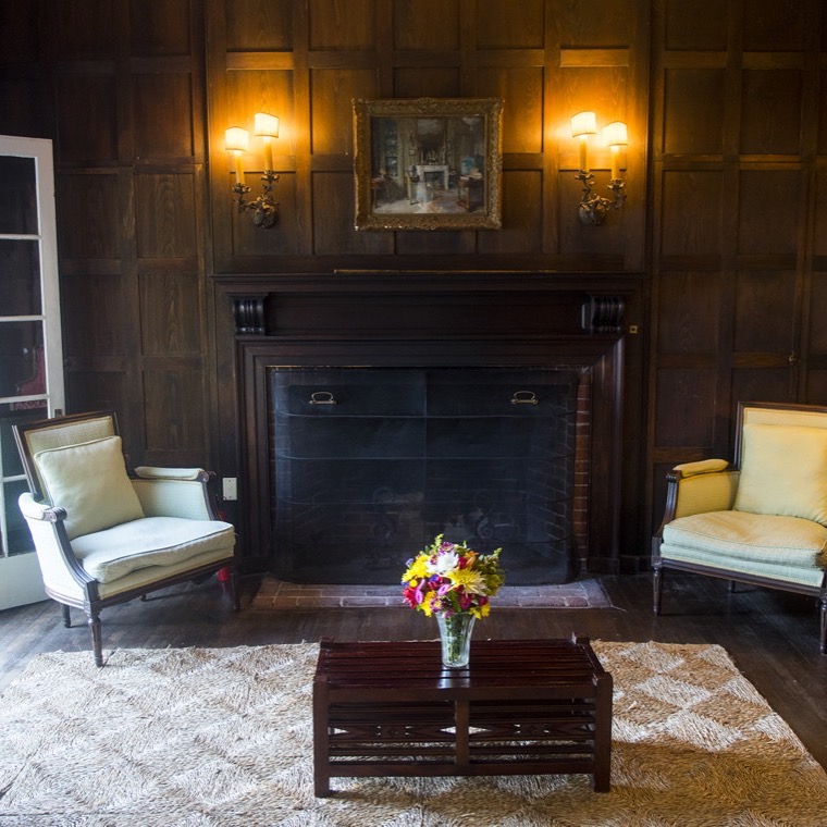 The library, lined with bookshelves and looking out high above Frenchman Bay